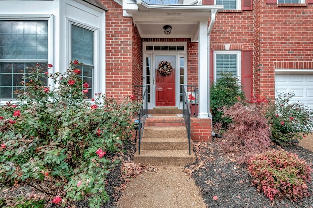 view of exterior entry with a garage