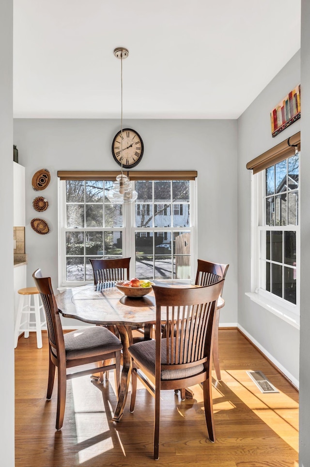 dining space with hardwood / wood-style floors