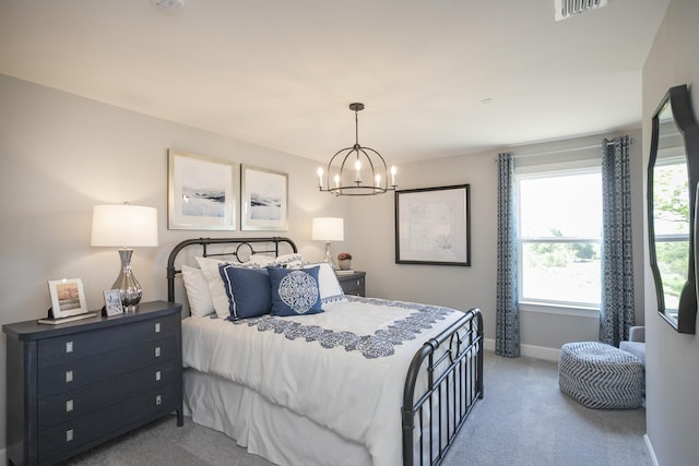 carpeted bedroom featuring a chandelier