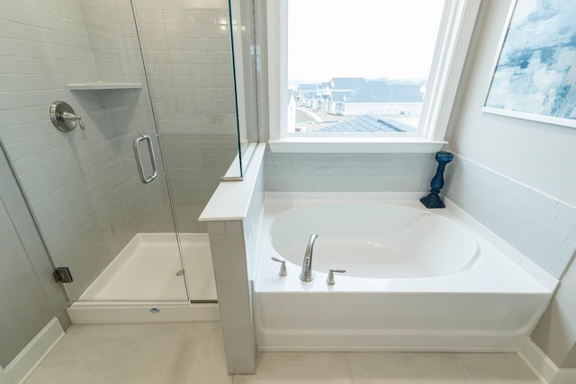 bathroom featuring separate shower and tub and tile patterned flooring