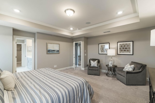 bedroom with light colored carpet, ensuite bath, ornamental molding, and a raised ceiling