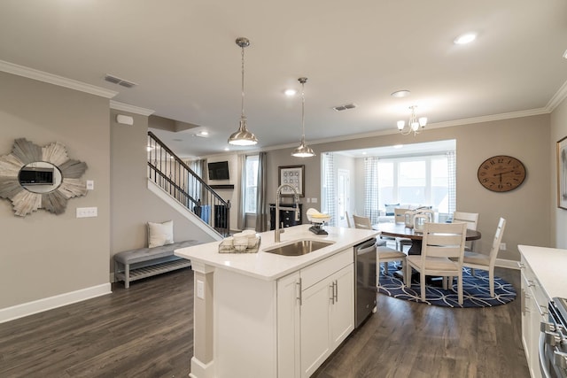 kitchen featuring an island with sink, stainless steel appliances, decorative light fixtures, dark wood-type flooring, and white cabinets