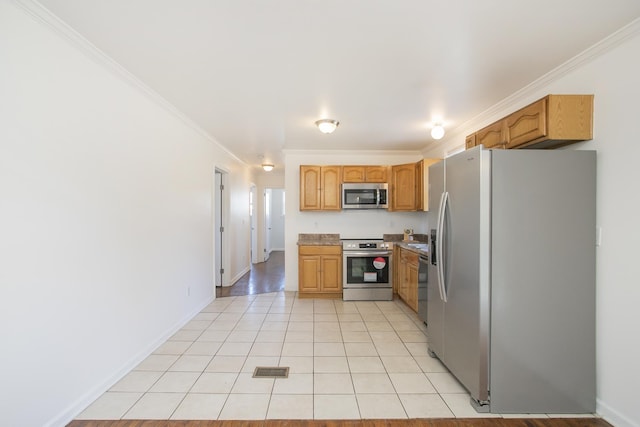 kitchen featuring light tile patterned floors, crown molding, and stainless steel appliances