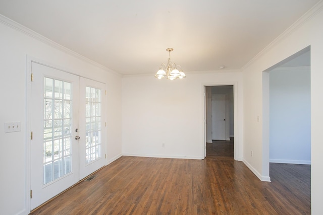 empty room featuring a wealth of natural light, dark wood-type flooring, ornamental molding, and french doors