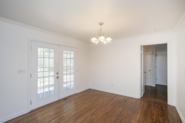 empty room with french doors, crown molding, a chandelier, and dark wood-type flooring