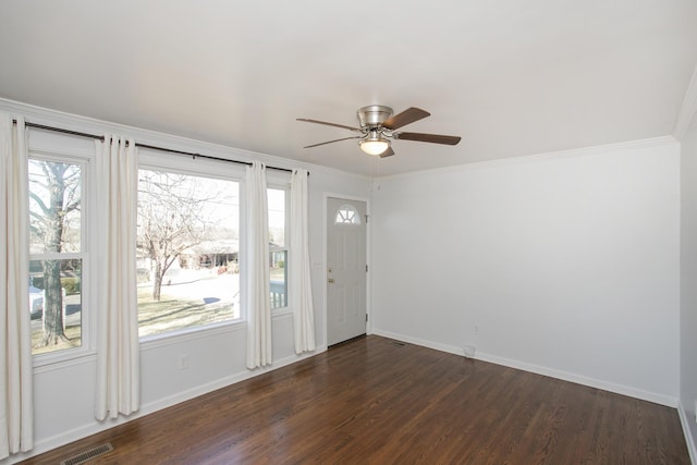 interior space with ceiling fan, ornamental molding, and dark hardwood / wood-style floors