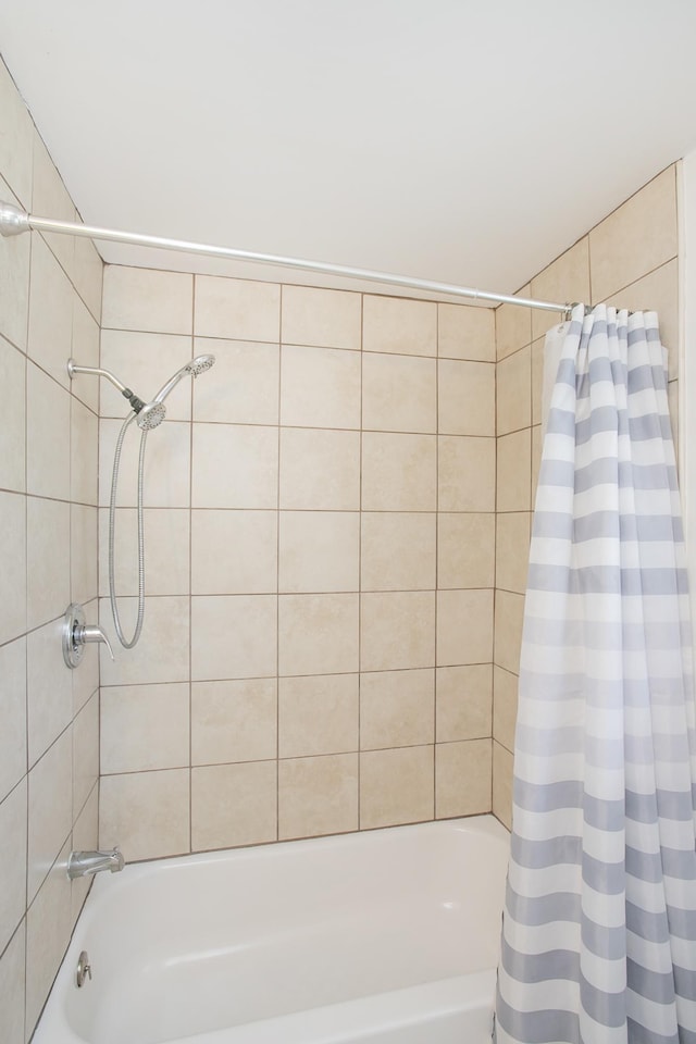 bathroom featuring shower / tub combo with curtain