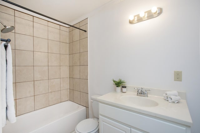 full bathroom featuring vanity, tiled shower / bath, and toilet