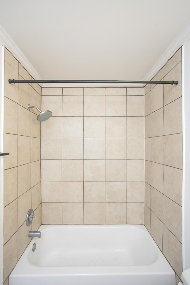 bathroom featuring tiled shower / bath and ornamental molding