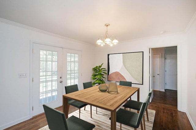 dining room featuring crown molding, dark wood-type flooring, french doors, and a chandelier