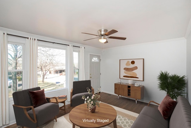 living room with dark hardwood / wood-style flooring, ornamental molding, and ceiling fan