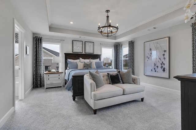 bedroom with light colored carpet, a tray ceiling, ornamental molding, and a notable chandelier