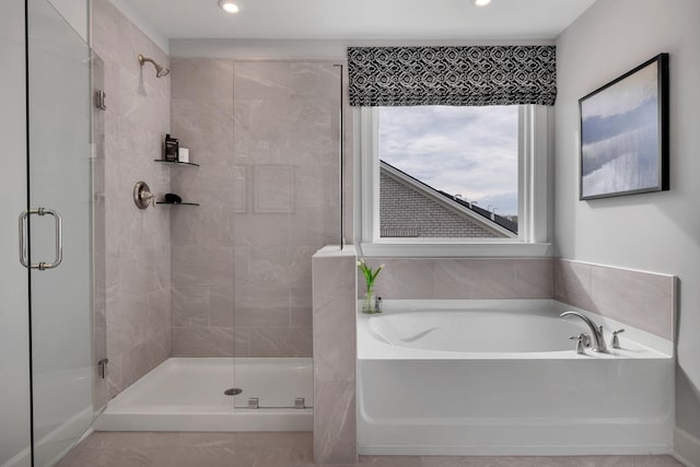 bathroom featuring shower with separate bathtub