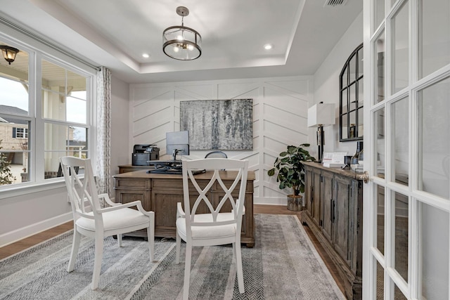 office featuring hardwood / wood-style floors and a raised ceiling