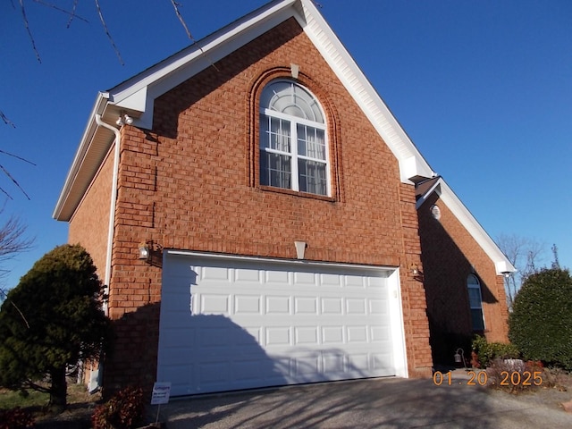 view of side of home featuring a garage