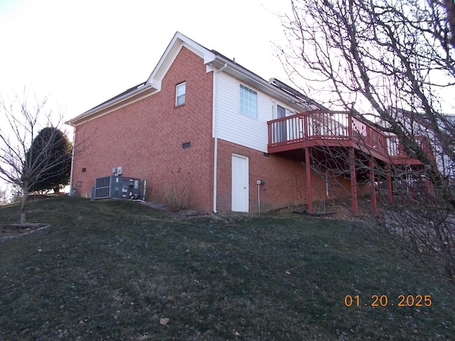 rear view of house with a deck and a lawn