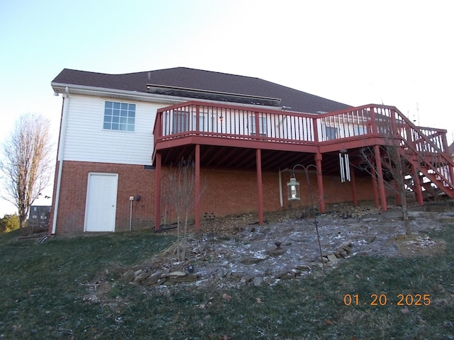 rear view of property featuring a yard and a wooden deck