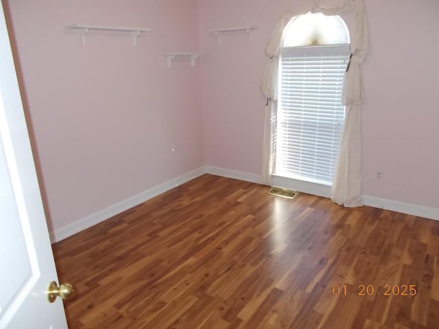 spare room with dark hardwood / wood-style flooring