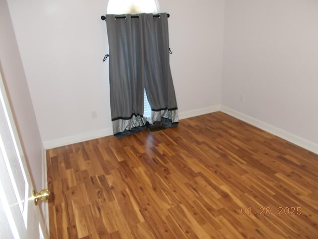 unfurnished room with hardwood / wood-style floors