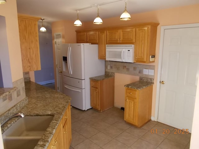 kitchen featuring light tile patterned floors, backsplash, white appliances, hanging light fixtures, and sink