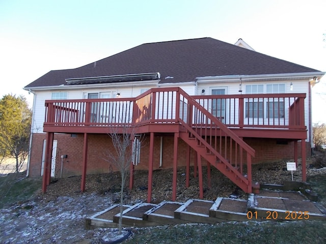 back of house with a deck