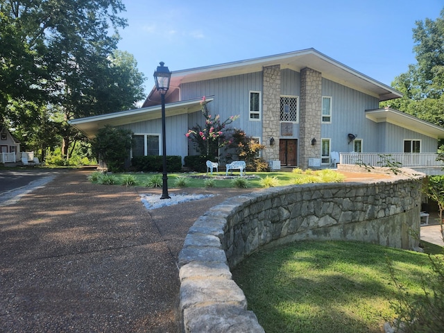 view of side of property with a lawn