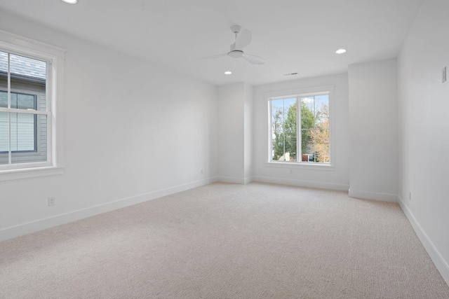 carpeted spare room with ceiling fan