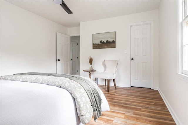 bedroom with wood-type flooring and ceiling fan