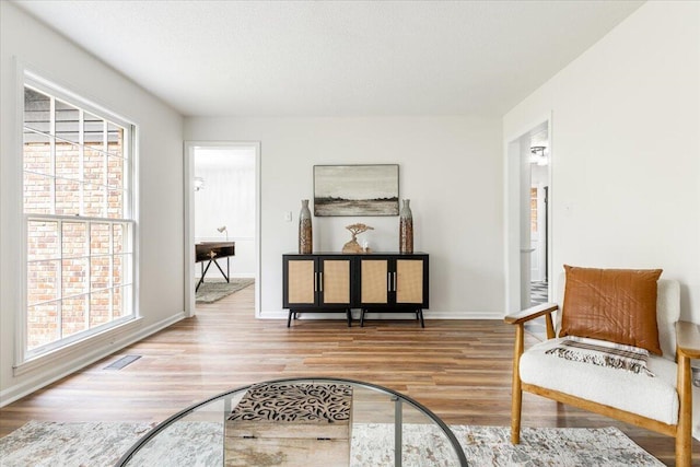 sitting room featuring a textured ceiling and light hardwood / wood-style floors