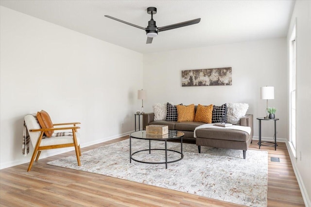 living room featuring hardwood / wood-style floors and ceiling fan