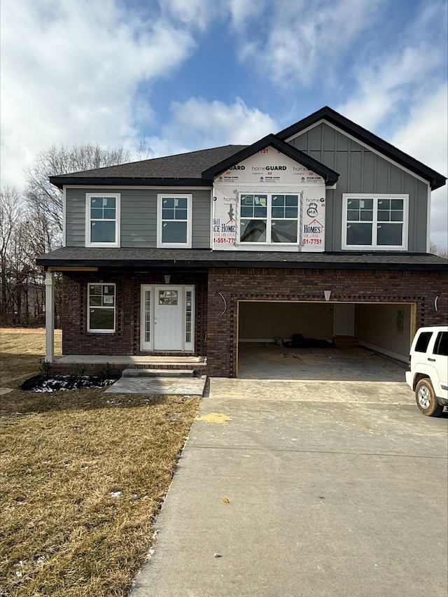 view of front facade with a garage and a front lawn