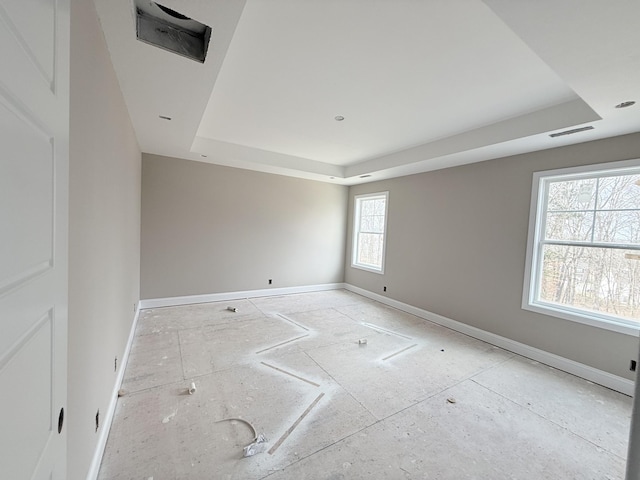 empty room featuring a tray ceiling