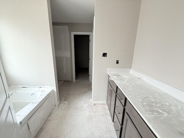 bathroom with vanity and a tub