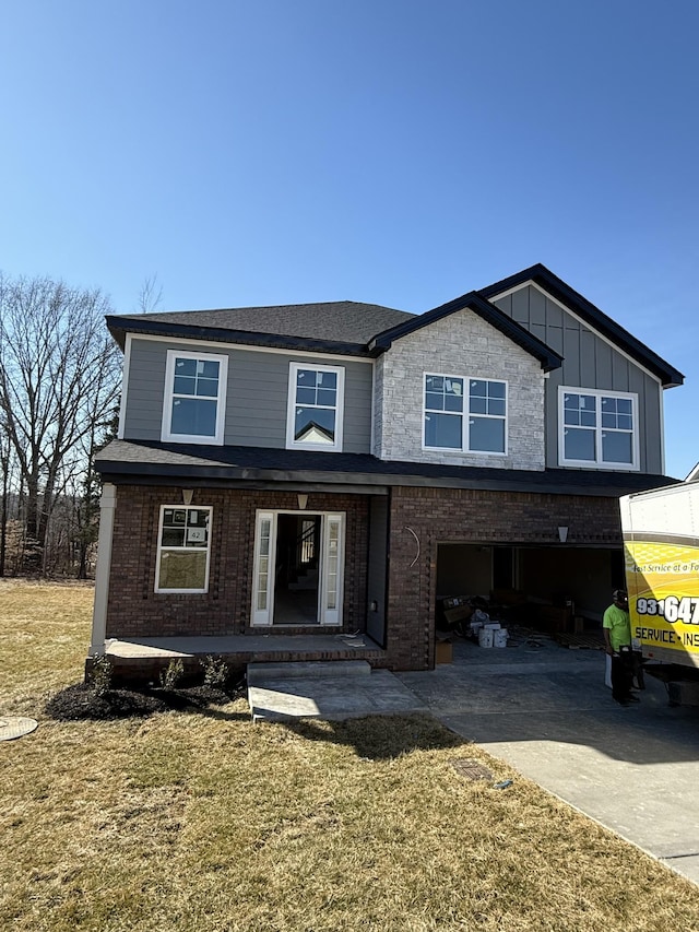 view of front of property with a garage and a front lawn