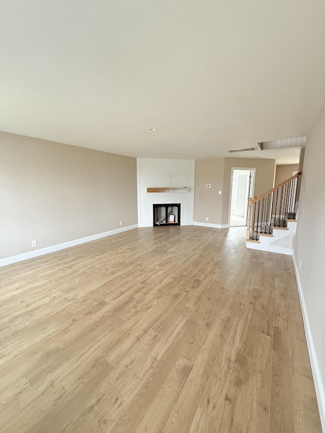 unfurnished living room featuring light wood-type flooring