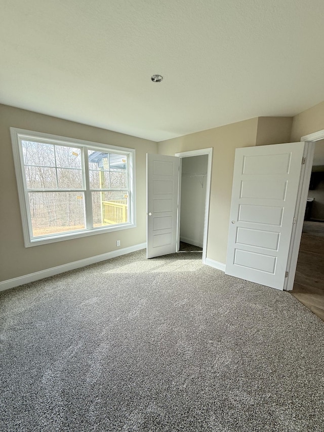 unfurnished bedroom featuring carpet floors and a closet