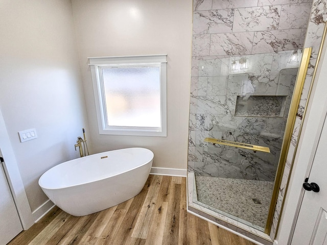 bathroom featuring wood-type flooring and independent shower and bath