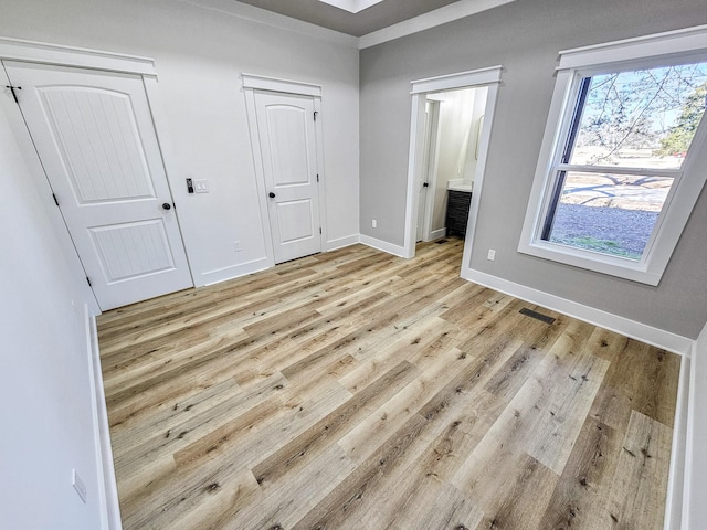 unfurnished bedroom featuring light wood-type flooring