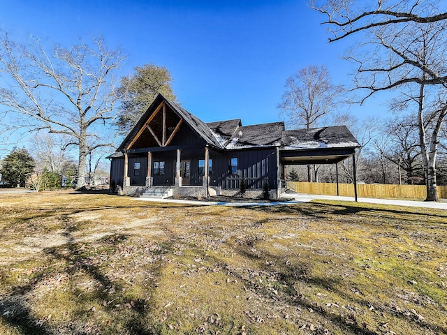 rear view of house with a yard and covered porch