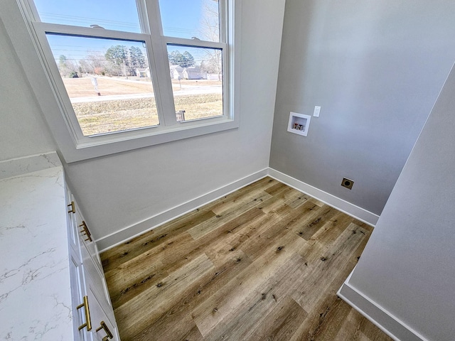 clothes washing area featuring washer hookup, hookup for an electric dryer, and hardwood / wood-style floors