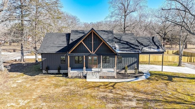 modern farmhouse style home featuring a carport, a porch, and a front yard