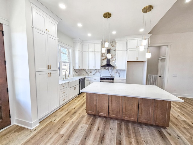 kitchen with decorative light fixtures, white cabinets, backsplash, and a kitchen island