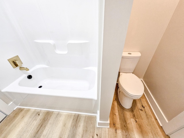 bathroom with toilet and wood-type flooring