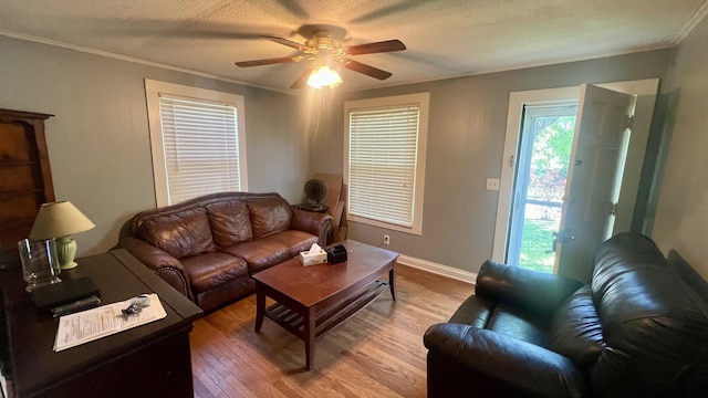 living room featuring a textured ceiling, ceiling fan, crown molding, and hardwood / wood-style flooring