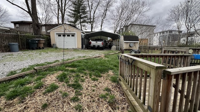 view of yard featuring a garage, an outdoor structure, and a carport