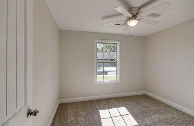 carpeted spare room with ceiling fan