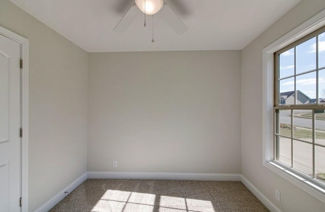 unfurnished room featuring light carpet and ceiling fan