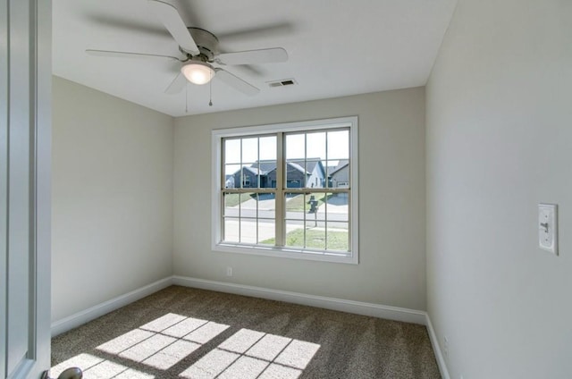 carpeted spare room with ceiling fan