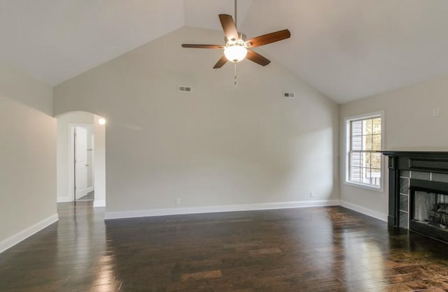 unfurnished living room featuring ceiling fan, a fireplace, dark hardwood / wood-style floors, and high vaulted ceiling