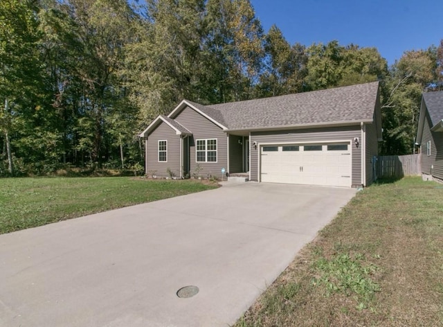 ranch-style home with a garage and a front lawn